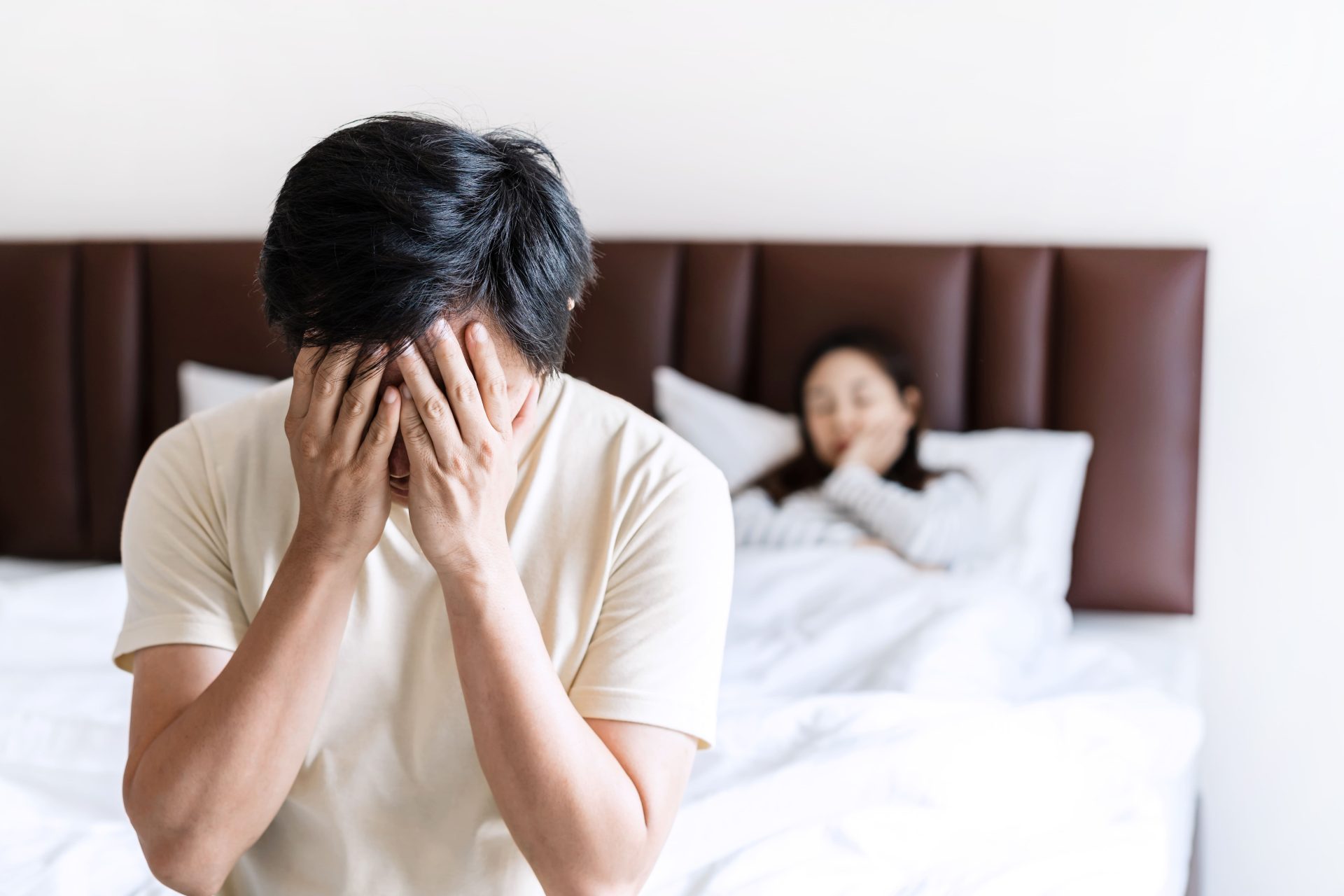 distressed man with woman in background in bedroom 2026 03 19 23 09 31 utc (1)